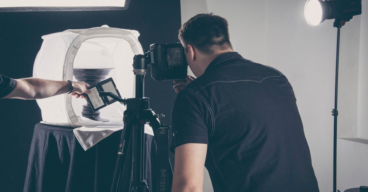 Photographer capturing product in a studio setup with lighting gear and camera.